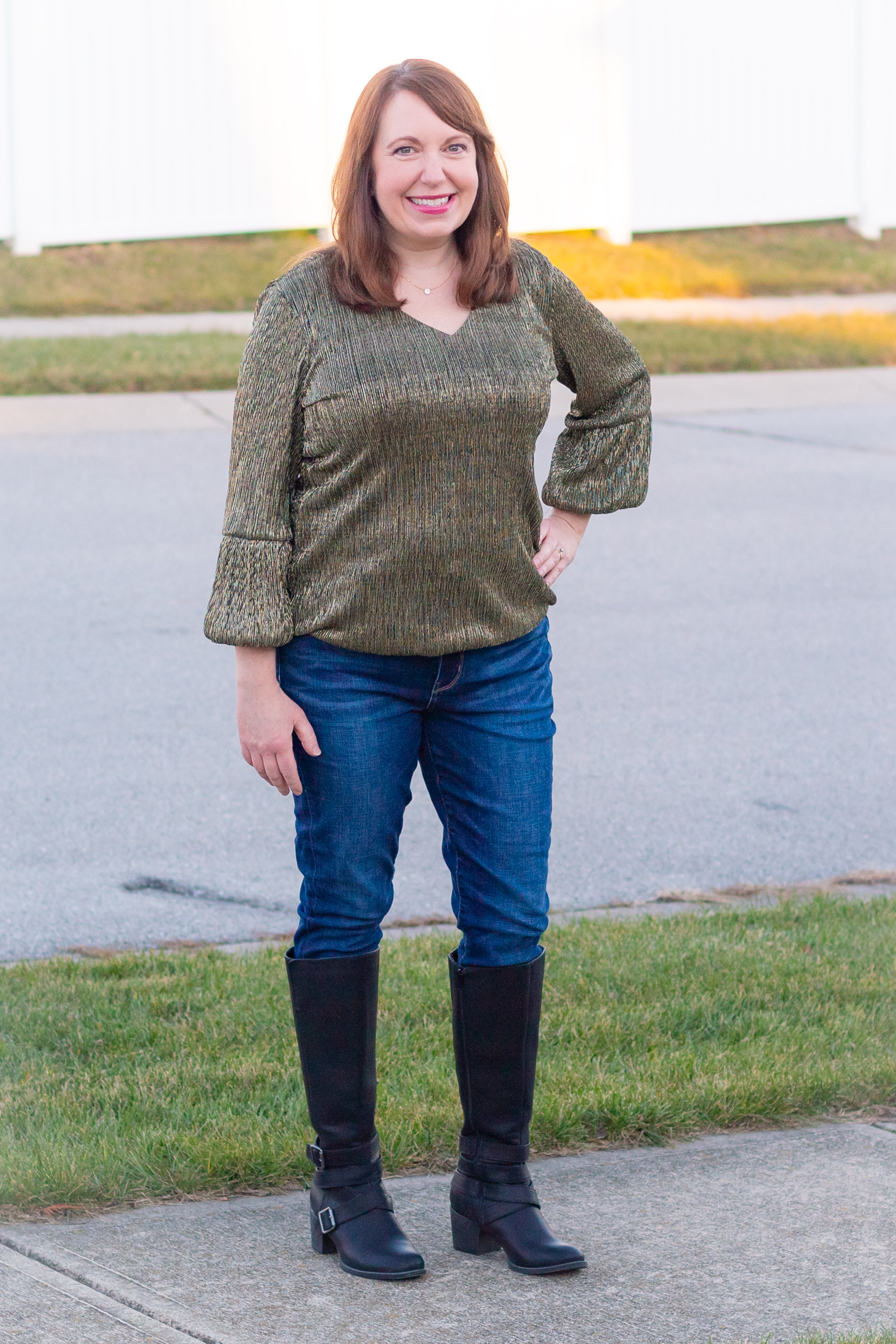 A Casual New Year's Eve Look with a Metallic Gold Top, Jeans, & Boots